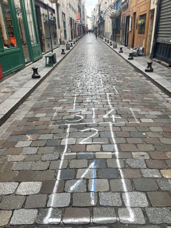 Charming and vibrant street scene in Bastille, Paris, showcasing fun and lively atmosphere, 2023. Photo by Leah Gillis highlighting local character and street activity.