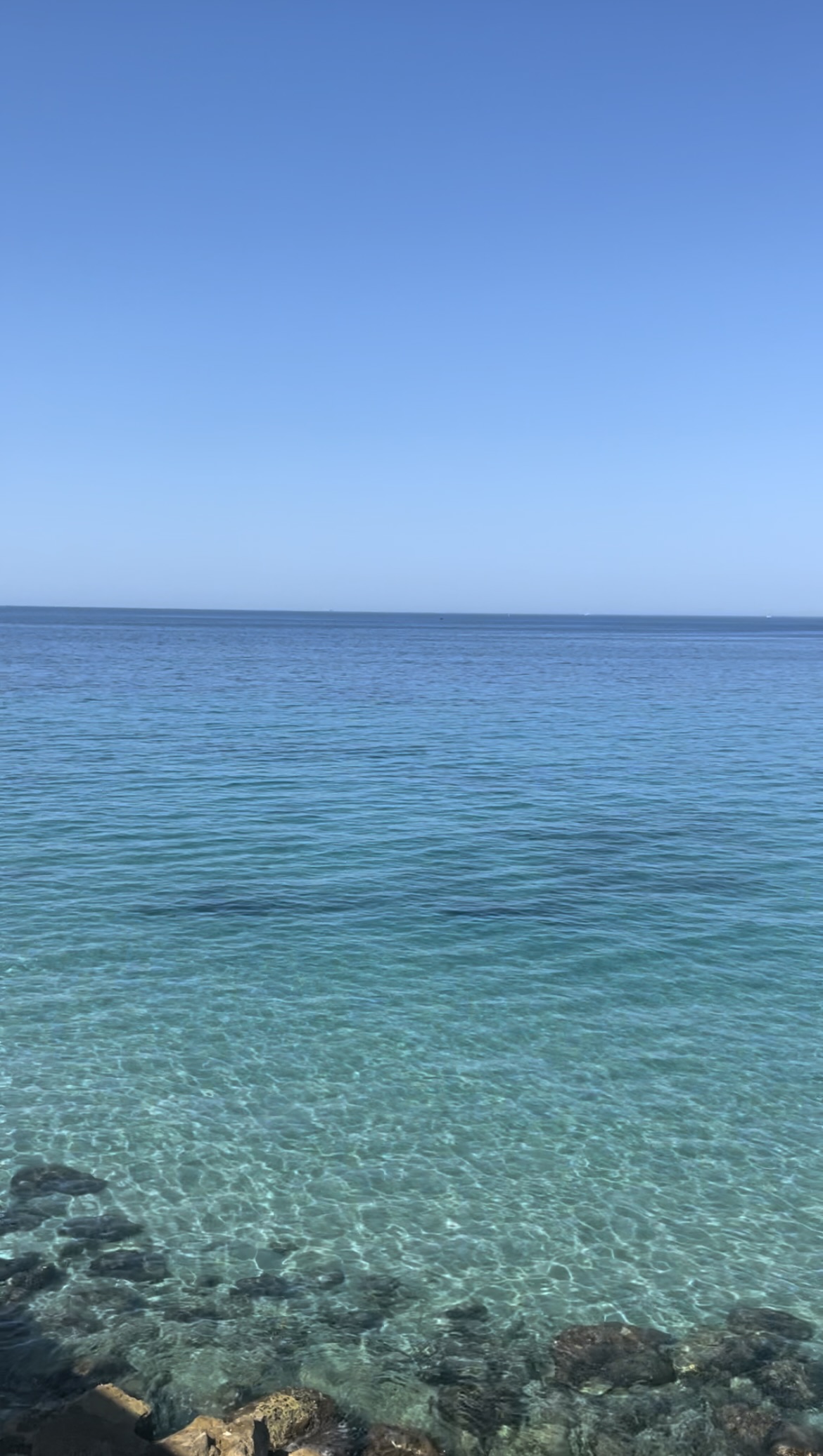 Still waters off the stunning coast of Marseille, France symbolizing the deep and introspective qualities of Neptune and Saturn in Pisces, reflecting the need for balance in our emotional lives.