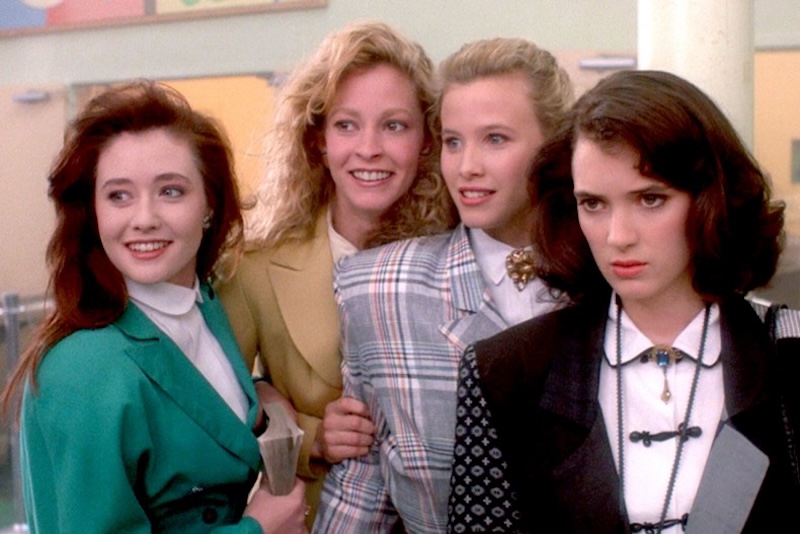 Scene from 1988 film Heathers illustrating themes of social conflict and emotional turmoil in groups of friends. (Does High School ever really end?!) Meghan Markle and Blake Lively's shared astrological aspect suggests ongoing struggles with social groups and personal pain throughout their lives. Everyone sure thinks they are a Heather.