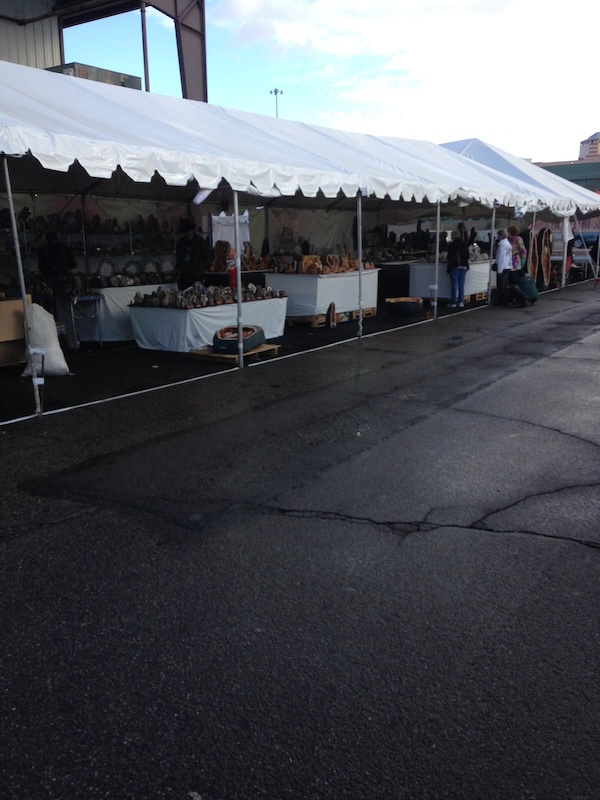 Rare gemstones and collector minerals displayed in huge cases at the Tucson Gem Show, the largest gem and mineral marketplace in the world.