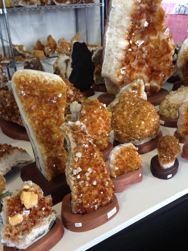 High-end crystal specimens and museum-quality minerals at the Tucson Gem and Mineral Show, attracting collectors, designers, and dealers.