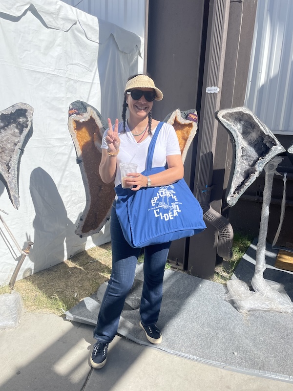 Leah Gillis enjoying the Tucson Gem Show atmosphere, surrounded by stones, sellers, and global community.