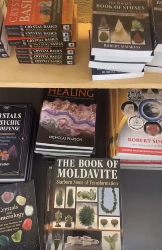 Spiritual and metaphysical books for sale at the Tucson Gem Show, showing the event’s connection to astrology, healing, and esoteric knowledge alongside minerals and crystals.