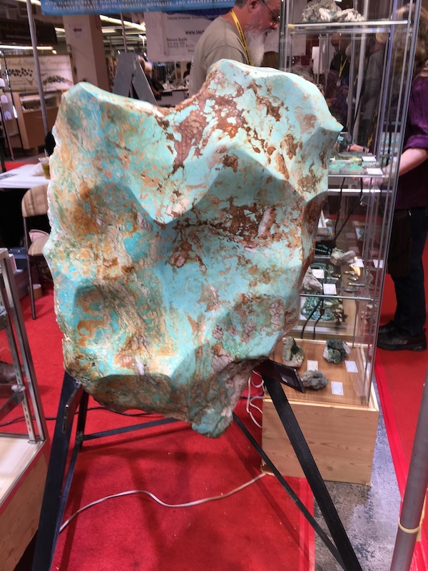 Inside one of the many vendor spaces at the Tucson Gem Show, where tents, exhibits, fossils, and world art make the event more than just a rock show.