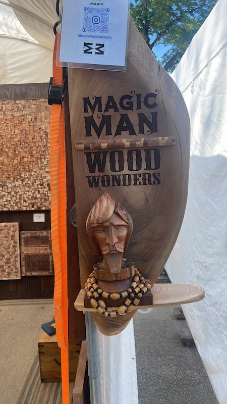 Artisan booth featuring handcrafted woodwork and mixed media art at Atlanta Dogwood Festival in Piedmont Park
