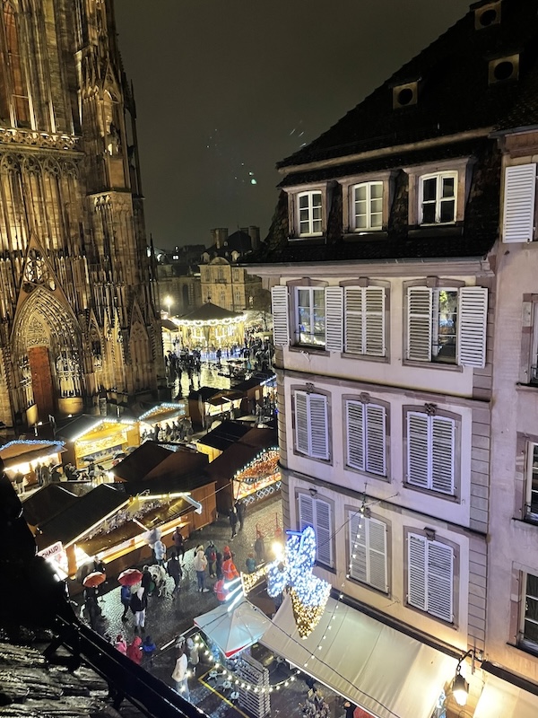 Christmas market scene in Strasbourg near cathedral with festive lights and holiday atmosphere
