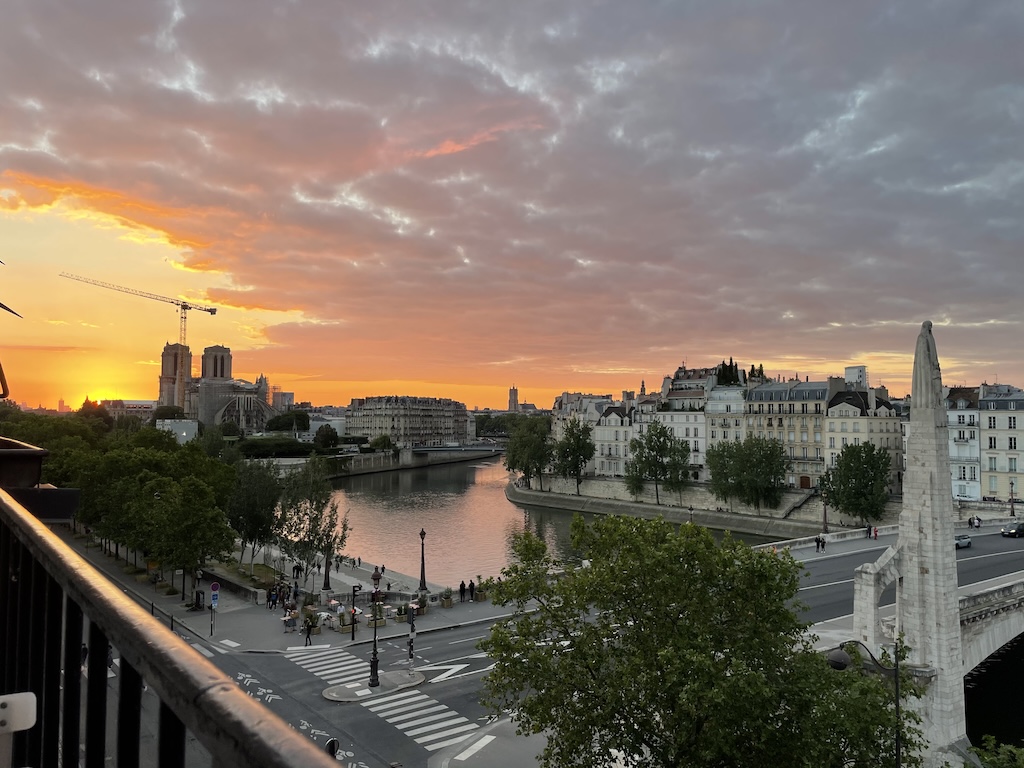 Golden sunset over Notre-Dame Cathedral and the Seine in Paris, France, symbolizing Leo season, creativity, joy, and the power of living from the heart.