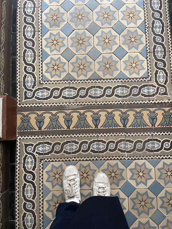 Antwerp Airbnb window with historic architectural details that inspired from the hallway entrance.
