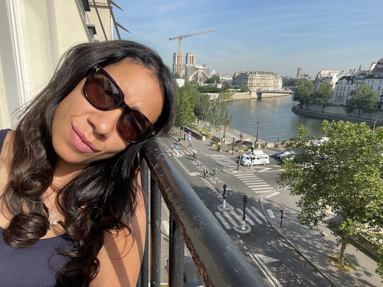 Paris street view from balcony with cafés, historic buildings, and everyday city life